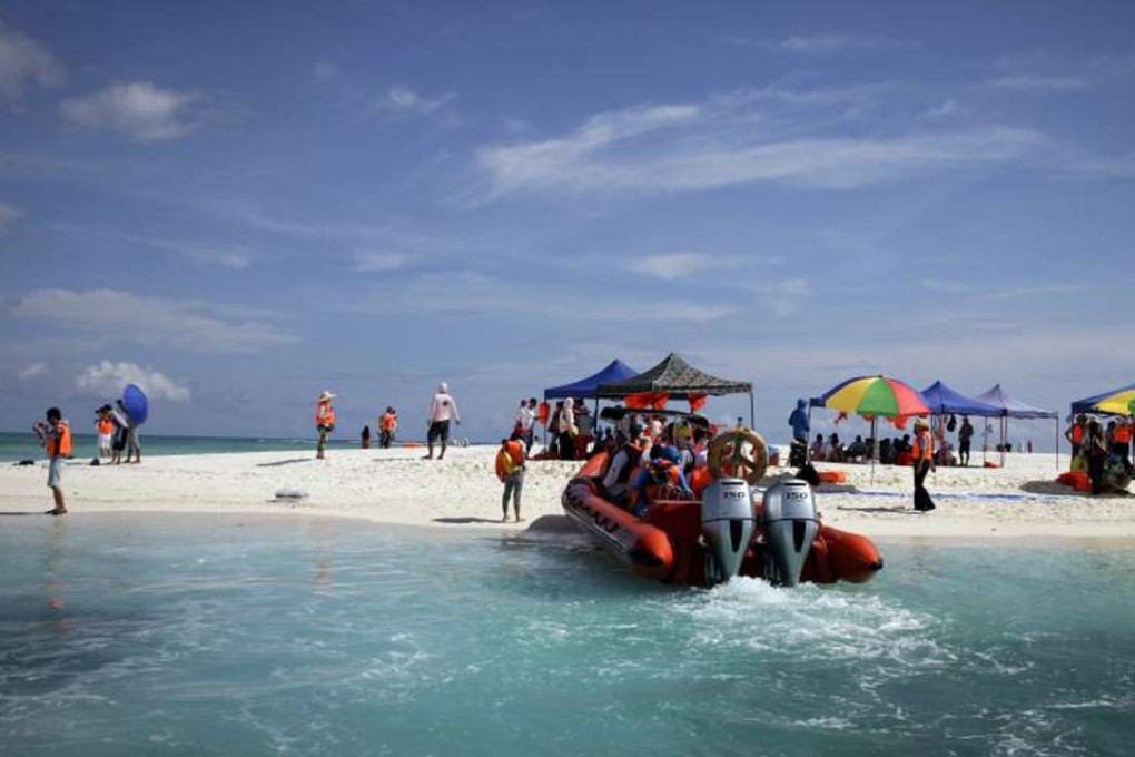 Chinese tourists visiting one of the Paracel Islands in a disputed area of the South China Sea. Photo: AP