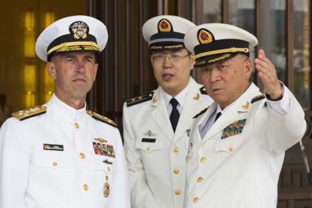 FILE - In this Monday, July 18, 2016, file photo, U.S. Chief of Naval Operations Adm. John Richardson, left, listens to Commander of the Chinese Navy Adm. Wu Shengli, right, at Chinese Navy Headquarters in Beijing. The top U.S. admiral said friendly exchanges with China's navy are conditional on safe and professional interactions at sea. Richardson's comments Wednesday, July 20, 2016, follow several fractious encounters between the two sides' ships and planes in and over the disputed South China Sea. (AP Photo/Ng Han Guan, Pool, File)