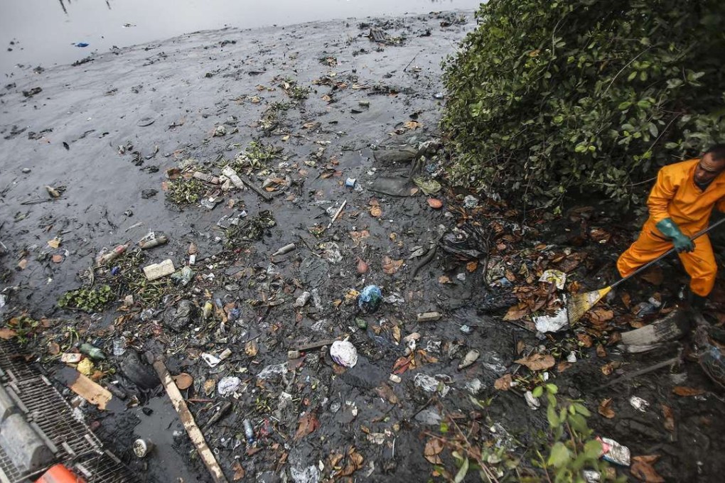 A man works on the cleaning of the Meirti river that flows into Guanabara Bay, where the sailing competitions will be held during the upcoming Rio 2016 Olympic Games in Brazil. Photo: EPA