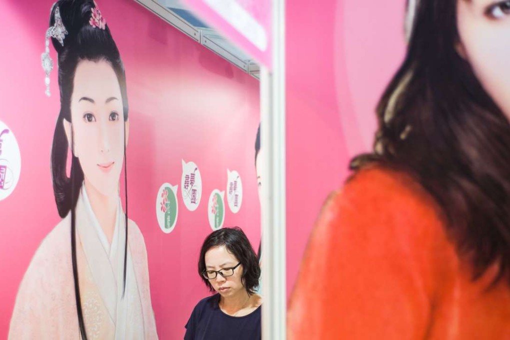 A woman browses books at the annual Hong Kong book fair in Wan Chai. Photo: AFP