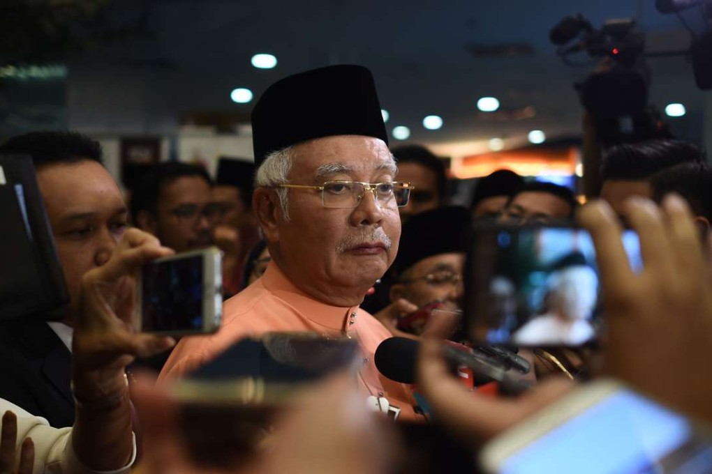 Malaysian Prime Minister Najib Razak is quizzed by reporters after an event in Kuala Lumpur on Thursday, a day after Singapore said it had seized nearly US$180 million linked to scandal-tainted state fund 1MDB. Photo: AFP