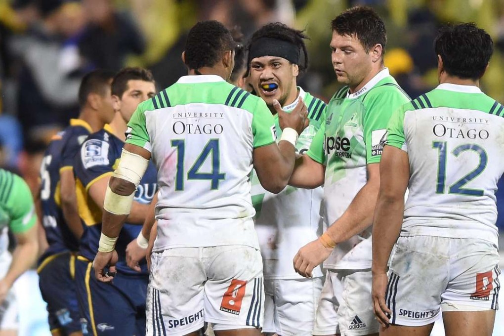 The Highlanders celebrate their win over the Brumbies on Friday. Photos: EPA