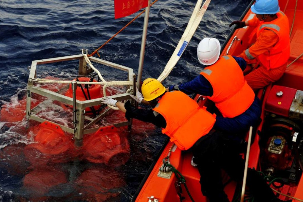 Crew on the research vessel Zhang Jian retrieve a submersible capable of diving up to 11,000 metres, in the South China Sea. Photo: Xinhua