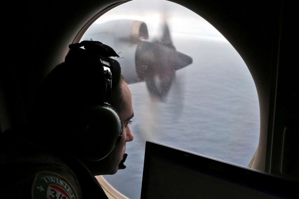 Flight officer Rayan Gharazeddine looks out of a Royal Australian Air Force (RAAF) AP-3C Orion as it flies over the southern Indian Ocean during the search for missing Malaysian Airlines flight MH370 March 22, 2014. Photo: Reuters