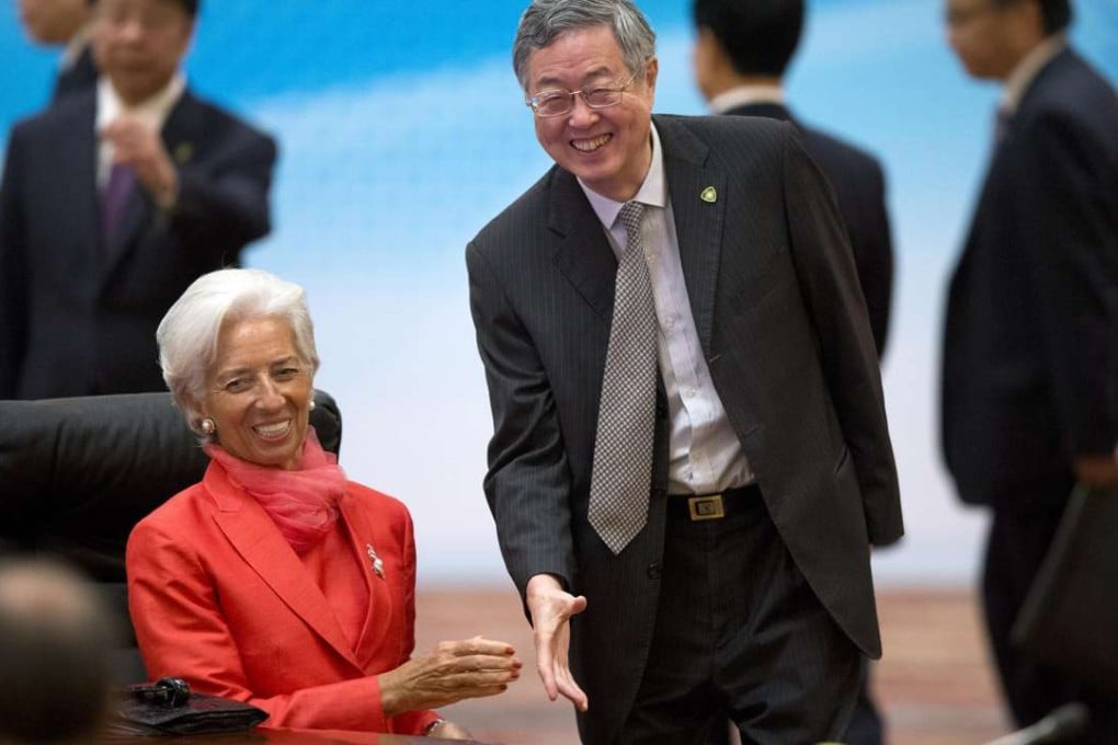 Zhou Xiaochuan (right), governor of the People's Bank of China, greets Christine Lagarde, managing director of the International Monetary Fund at a meeting in Beijing on Friday. Photo: EPA