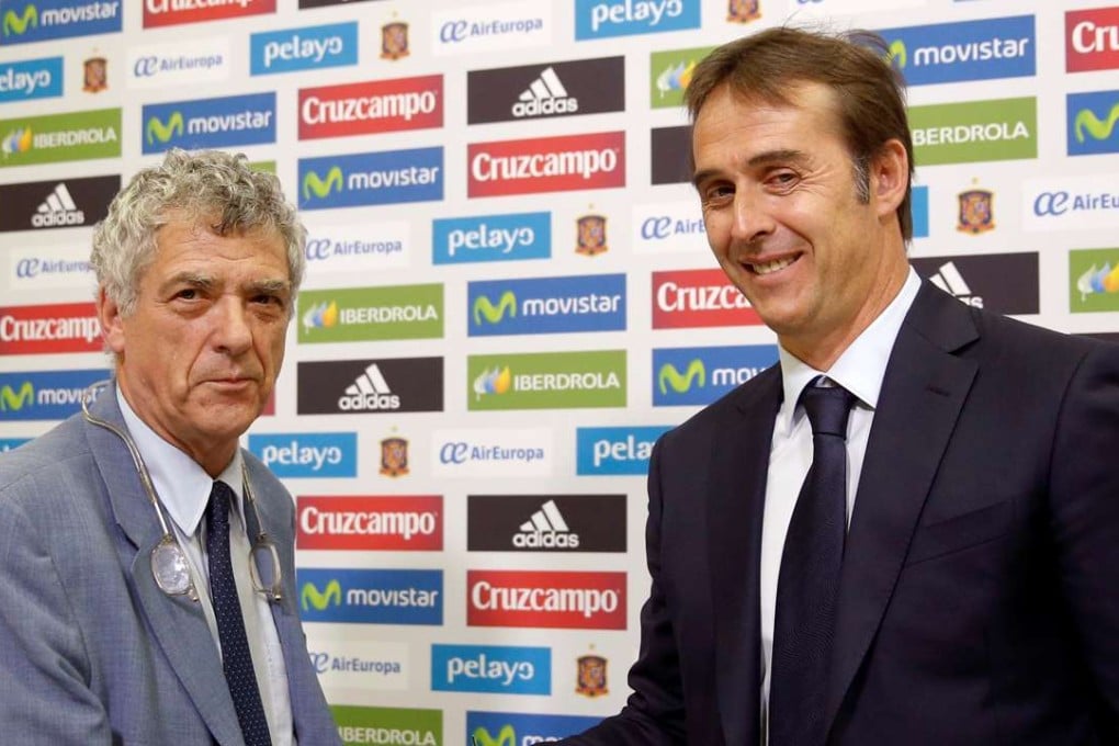 Julen Lopetegui (right) shakes hands with Angel Maria Villar, Spain's football federation president. Photo: Reuters