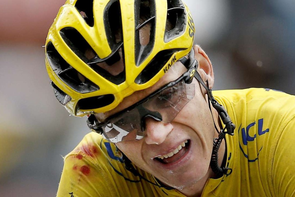 Chris Froome battles the pain to finish after crashing and then borrowing a teammate’s bike to continue. Photo: EPA