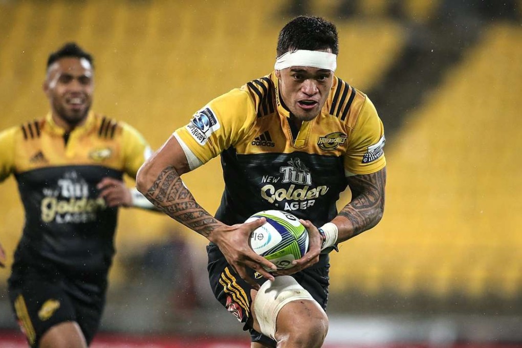 Vaea Fifita of the Hurricanes breaks away to score a try against the outclassed Coastal Sharks in Wellington. Photo: AFP
