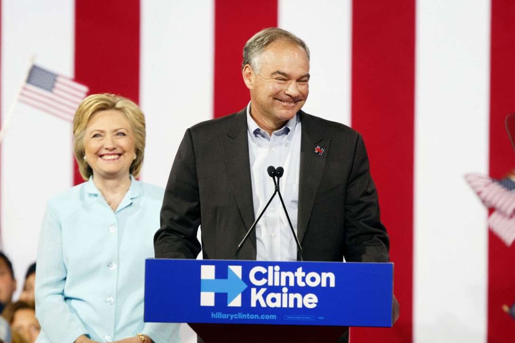Tim Kaine, presumptive 2016 Democratic vice presidential nominee, smiles on stage with Hillary Clinton, presumptive 2016 Democratic presidential nominee, during a campaign event in Miami, Florida, US, on July 23, 2016. Photo: Bloomberg