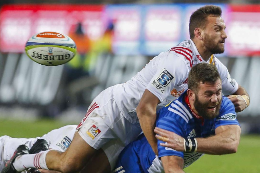 Stormers' Jaco Taute is tackled by Aaron Cruden of the Chiefs during their Super Rugby quarter-final on Saturday. Photo: EPA
