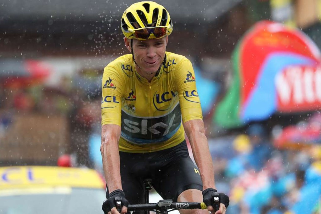All but sealed: Chris Froome doesn’t mind the rain as he heads towards the finish line of the 20th stage, knowing he is on the verge of claiming a third Tour de France title. Photo: AFP