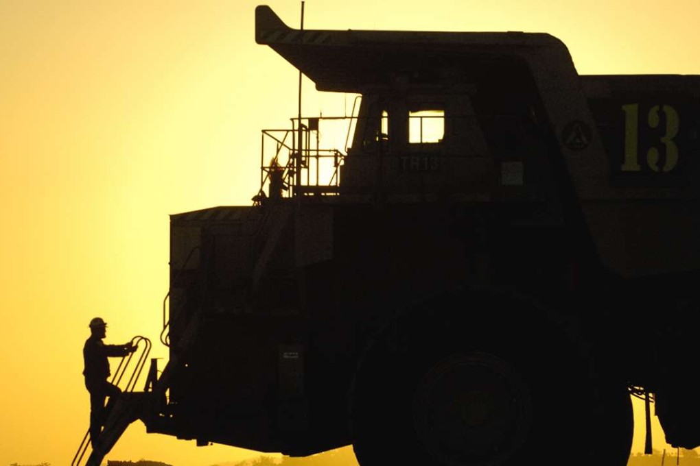 A driver climbs from a haul truck at the Bengalla coal mine in the Hunter Valley north of Sydney. Baker & McKenzie says deal volumes are being influenced by whether Australian coal mines are being sold. Photo: Reuters