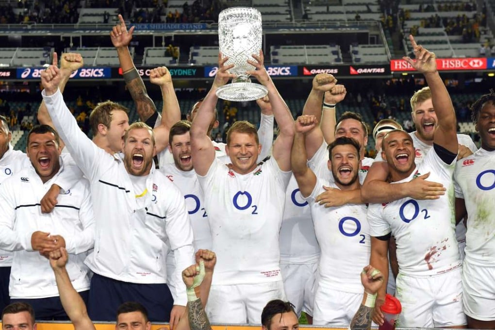 England captain Dylan Hartley lifts the winners' trophy with team-mates following their victory over Australia in the third Test in Sydney in June. Photo: AFP