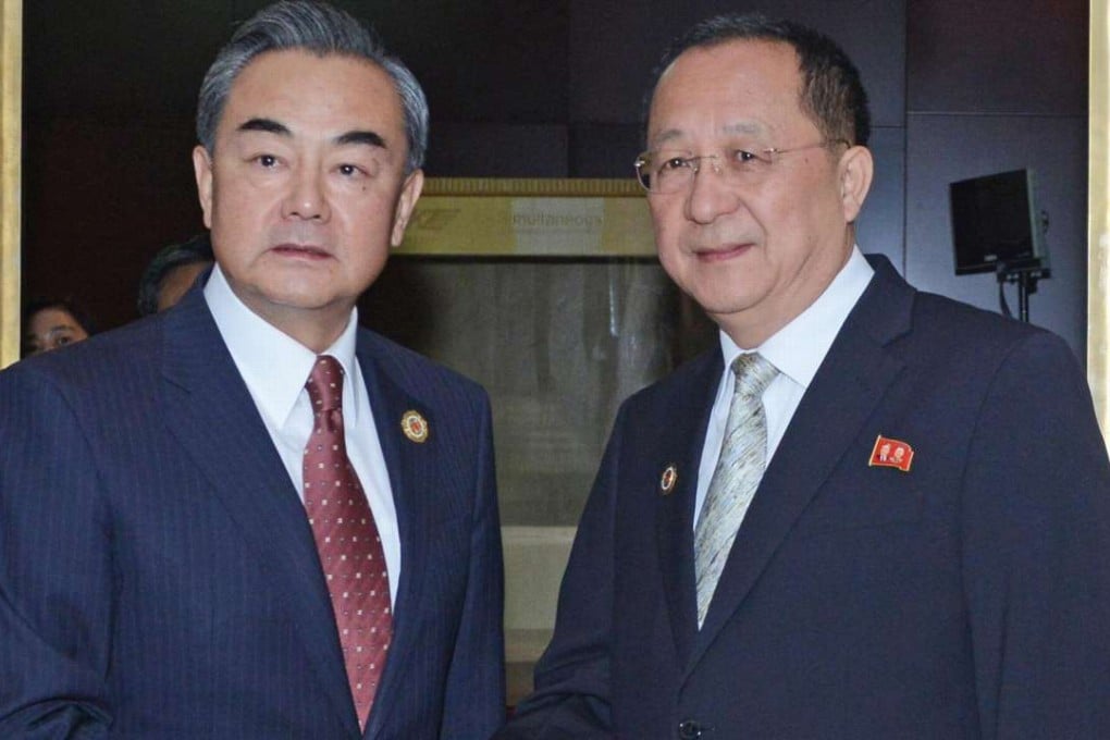 Chinese Foreign Minister Wang Yi (left) mAgeets North Korean Foreign Minister Ri Yong-ho in Vientiane, Laos, on Monday. Photo: Xinhua