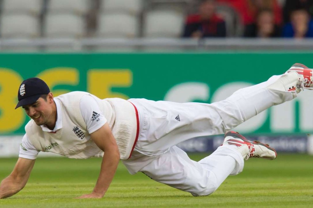 England captain Alastair Cook dives to field off the bowling of Moeen Ali on the fourth day of the second test against Pakistan at Old Trafford. England beat Pakistan by 330 runs to level the series. Photos: AFP