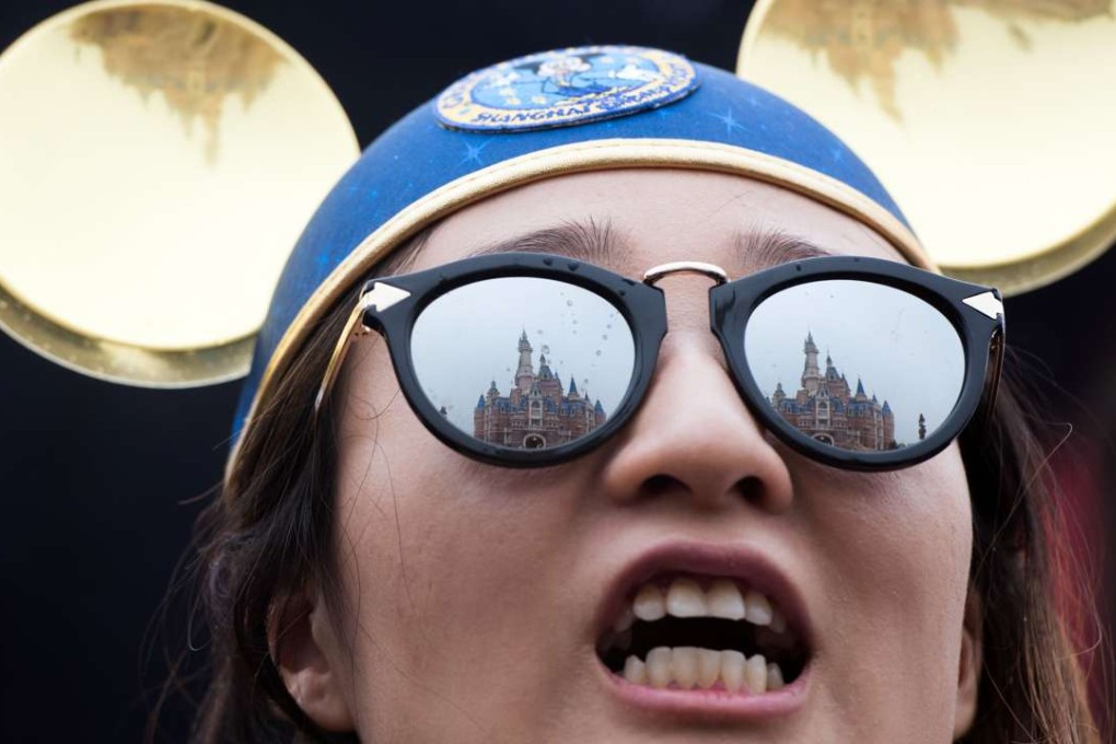 The Enchanted Storybook Castle is reflected in the sunglasses of a girl during the opening ceremony of the Shanghai Disney Resort. Photo: AFP