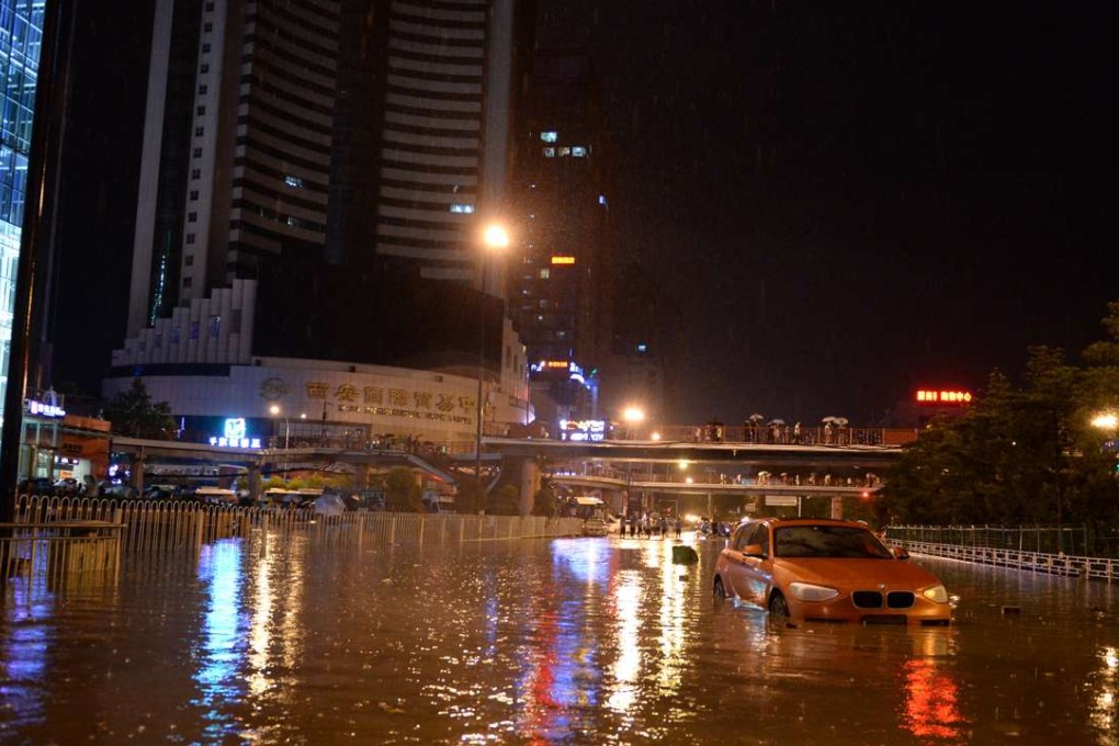Floodwaters reached more than a metre deep in parts of Xian, the capital of Shaanxi province. Above, a stranded car on Sunday night. Photo: Xinhua
