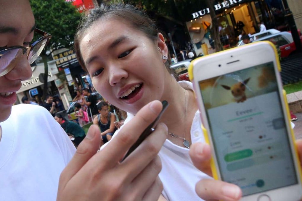 Hongkongers play the mobile game Pokemon Go, which is expected to prove a boost to Lenovo. Photo: David Wong