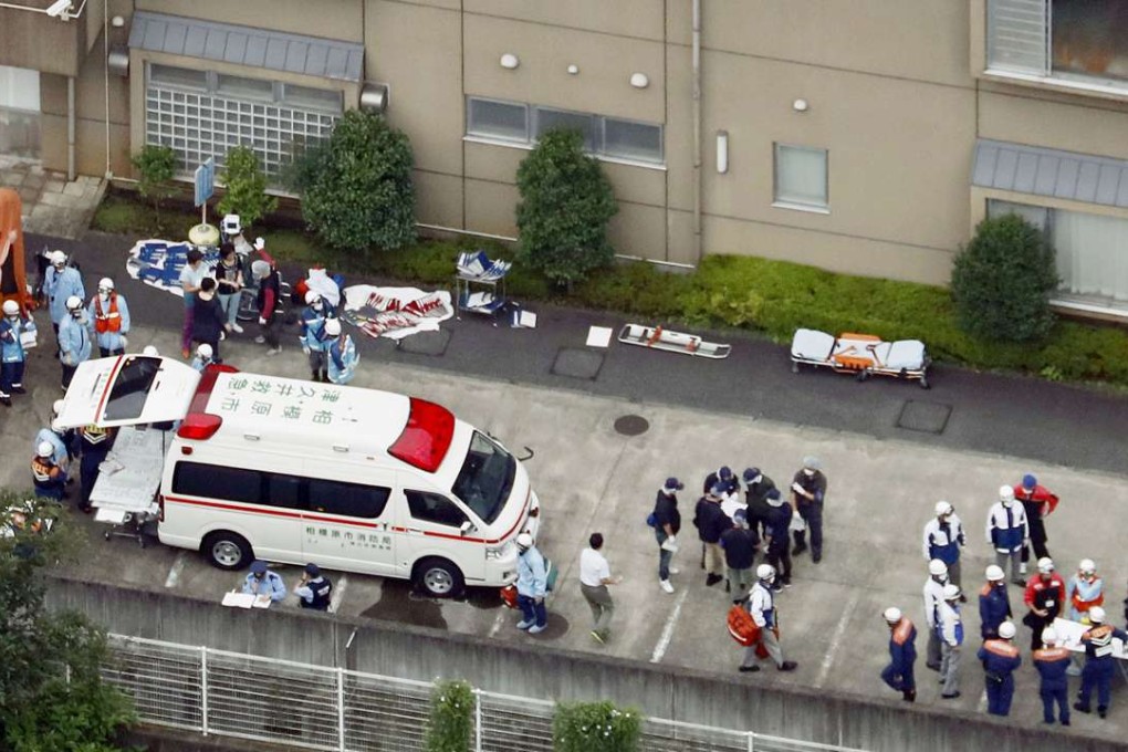 Ambulance crew and police officers are seen outside a facility for the handicapped in Sagamihara, outside Tokyo, where a mass stabbing took place on Tuesday. Photo: Kyodo