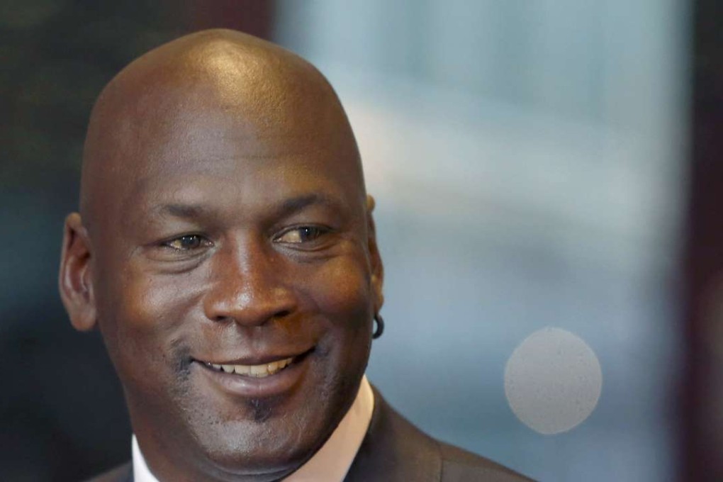 Former NBA star and current owner of the Charlotte Hornets, Michael Jordan, smiles at reporters in Chicago. Jordan announced Monday he’s giving $1 million to the Institute for Community-Police Relations and $1 million to the NAACP Legal Defense Fund to help build trust between blacks and law enforcement following several disturbing clashes around the country. Photo: AP