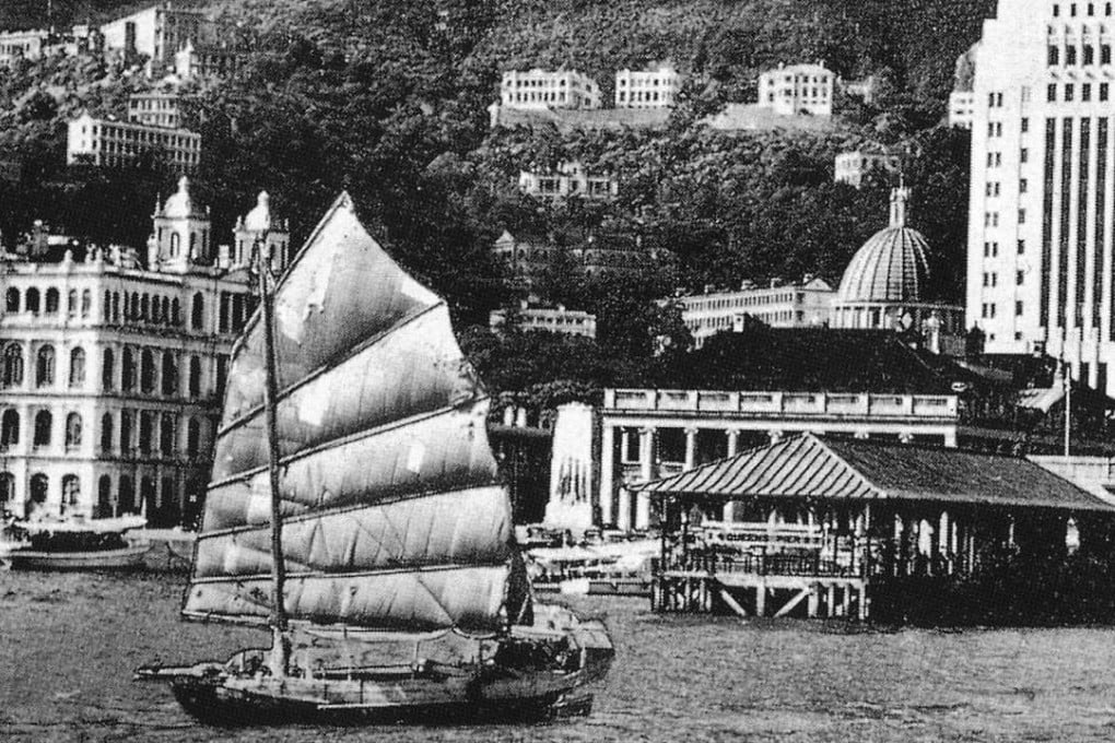 A scene from about 1952 of Central as a Chinese junk passes Victoria Harbour ferry terminal on Hong Kong Island, taken from the new book, Hong Kong Then and Now. Photo: Getty/Pavilion Books