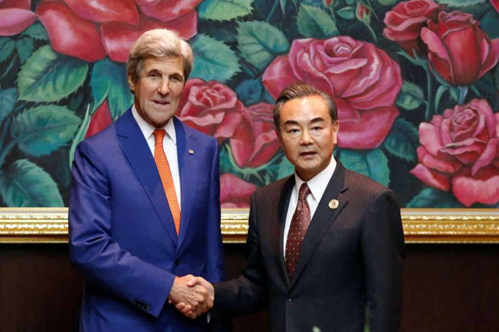 US Secretary of State John Kerry shakes hands with Foreign Minister Wang Yi on the sidelines of the Asean foreign ministers meeting in Vientiane, Laos, on Monday. Photo: Reuters