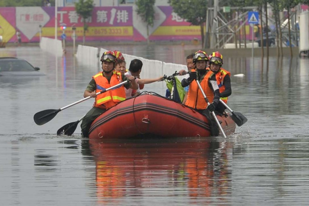 Rescuers navigate a flooded road in Shenyang, Liaoning province, northeast China on Monday. Photo: EPA