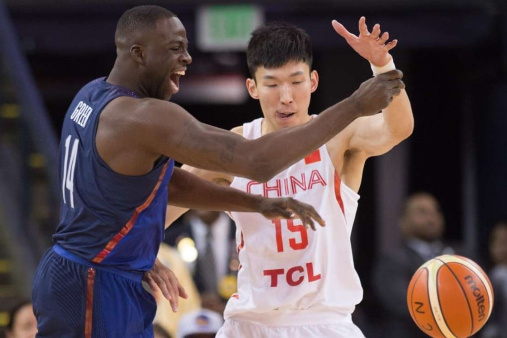 Zhou Qi China’s vies for the ball with Draymond Green of the USA during a friendly match at the Oracle Arena in Oakland, California. Photo: Xinhua
