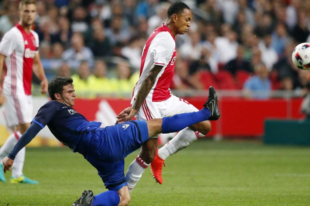Ajax’s Kenny Tete comes together with Charis Charisis of PAOK during their Uefa Champions League third qualifying round first leg tie. Photo: EPA