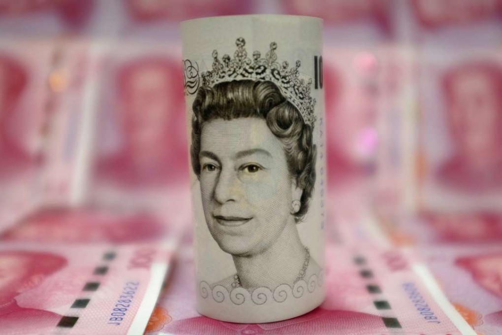 A British 10-pound banknote amid Chinese 100-yuan banknotes. Photo: Reuters