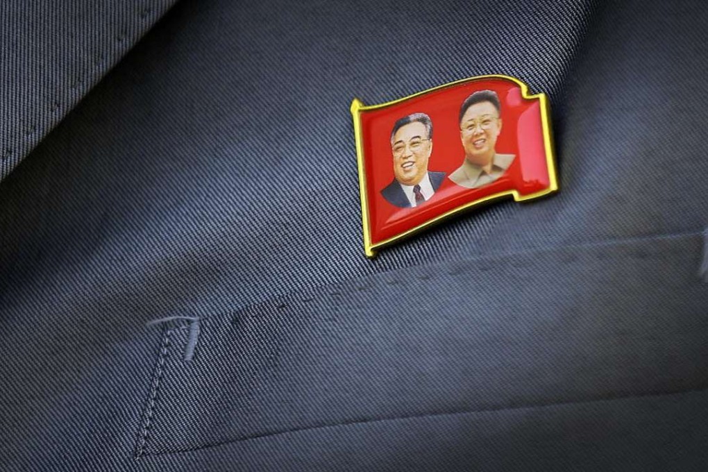 All North Koreans must wear lapel pins carrying the images of both Kim Jong-il and his father Kim Il-sung or the images of either of them. Photo: AP