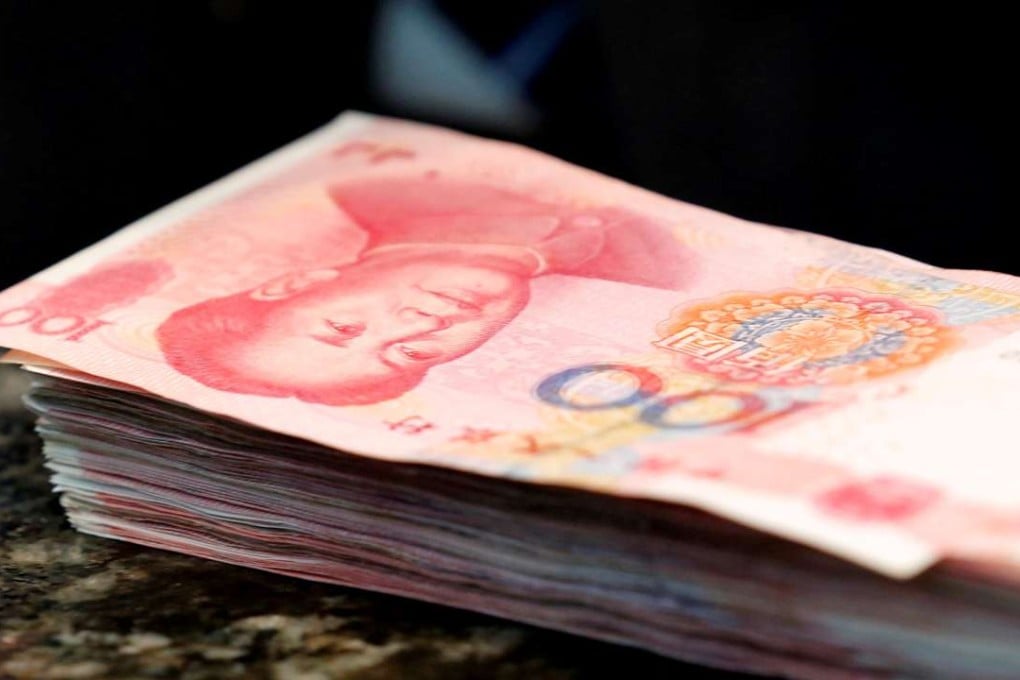 Chinese 100 yuan banknotes are seen on a counter of a branch of a commercial bank in Beijing, China. Photo: Reuters