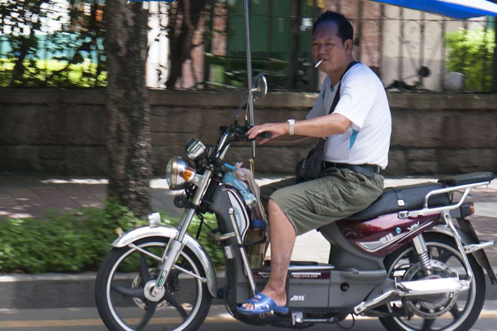 A man rides an e-bike in Shenzhen. Photo: Stuart Heaver
