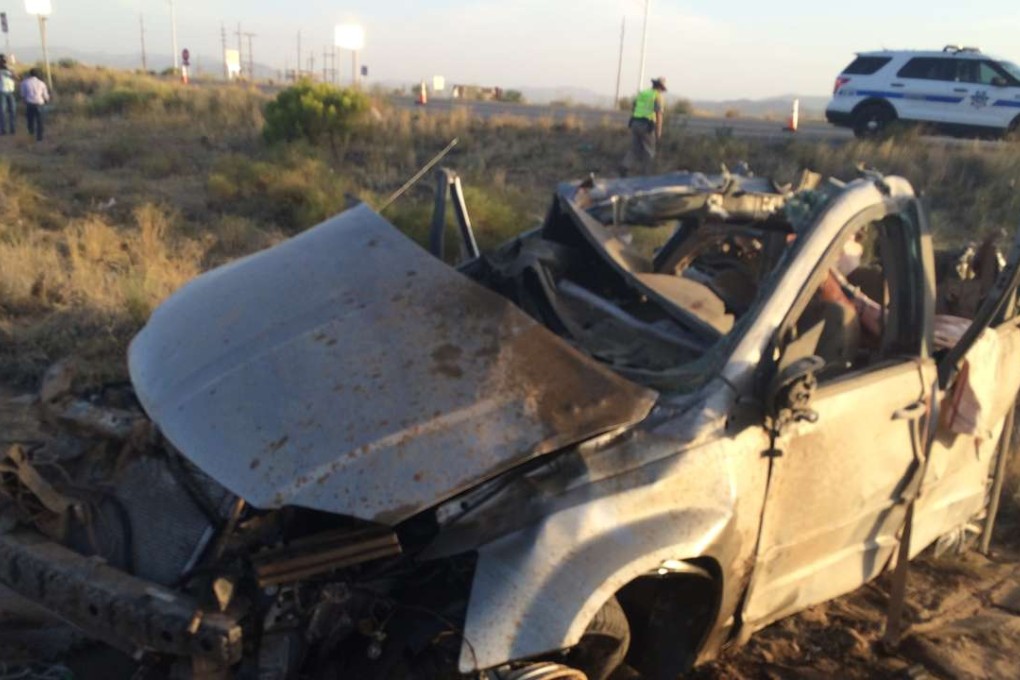 The wreckage of a van that collided with a Dallas Cowboys bus, killing four Chinese people. Photo: AP