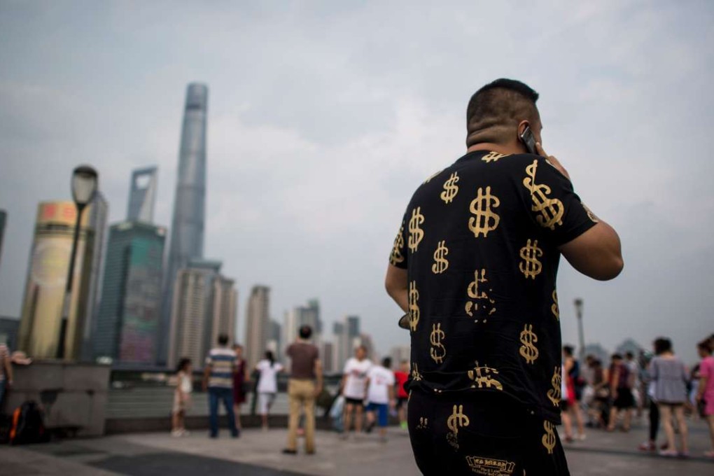 A man walks down the Bund overlooking the financial district of Pudong in Shanghai. Chinese workers have grown accustomed to rising prosperity. Photo: AFP