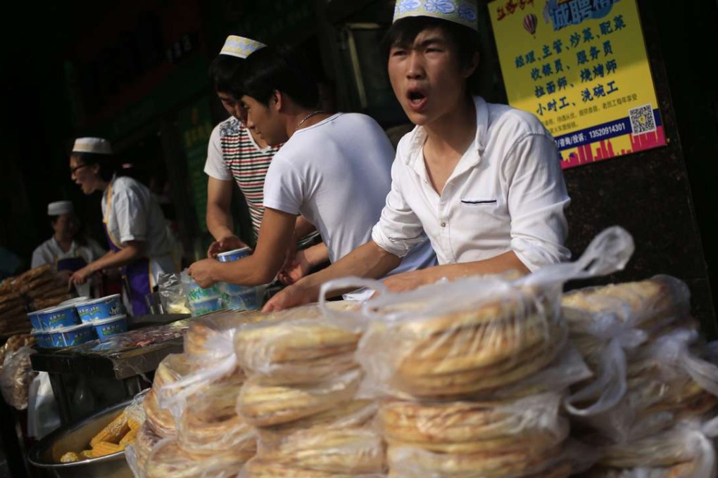 Muslim food vendors sell their goods outside the Niujie Mosque in Beijing during celebrations for the Eid ul-Fitr festival. Photo: EPA