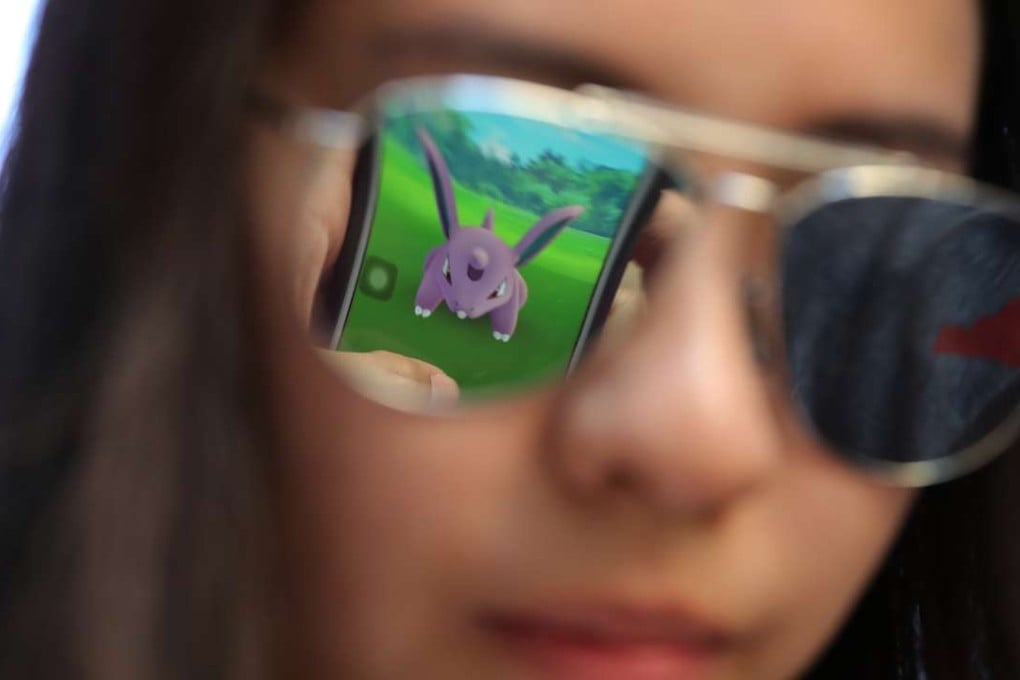 A mobile screen is reflected on a woman’s sunglasses as she plays Pokemon Go in Hong Kong. However you feel about Pokemon, the act of augmenting reality has been around for longer than any one of us has been. Photo: AP