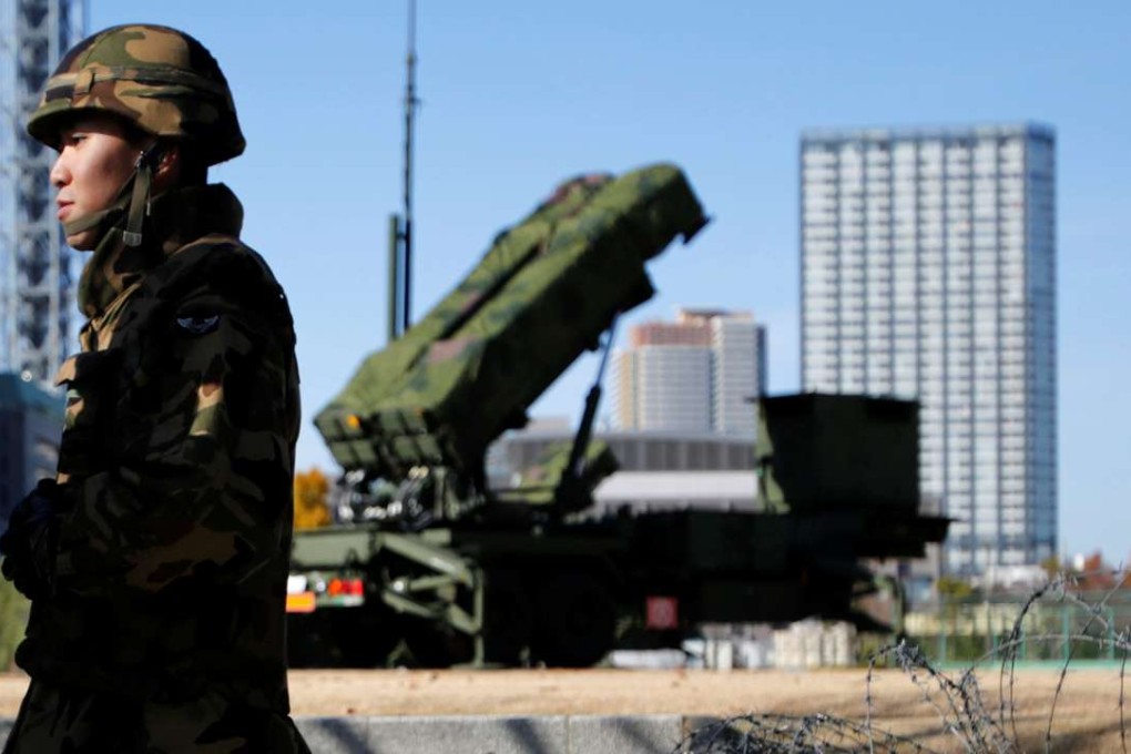 Members of the Japan Self-Defence Forces stand guard near Patriot Advanced Capability-3 (PAC-3) land-to-air missiles, deployed at the Defence Ministry in Tokyo. Photo: Reuters