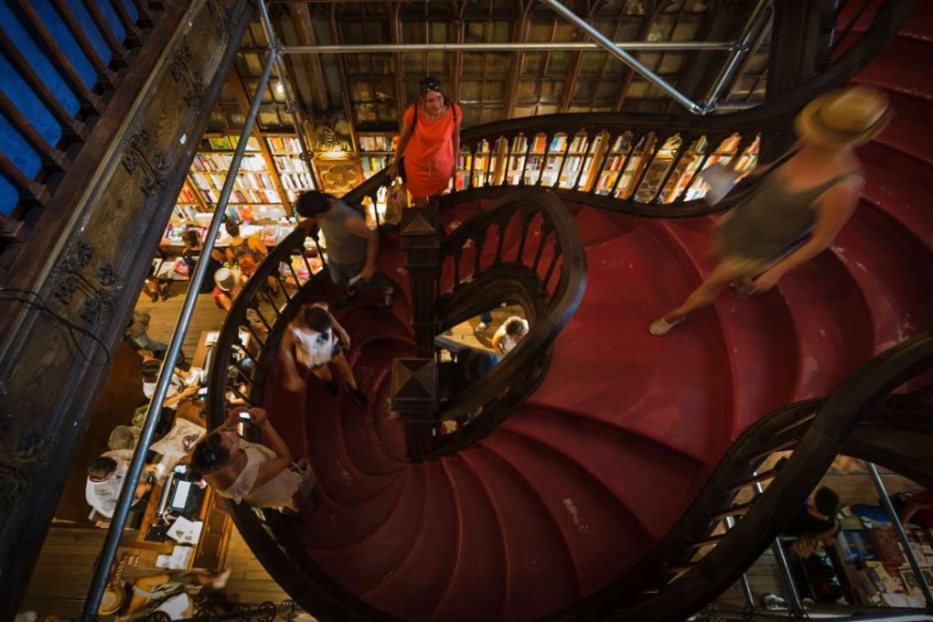 Tourist descend a staircase at the Lello bookstore in Porto – which bears a resemblance to the Grand Staircase at Hogwarts school of wizardry. Photos: AFP