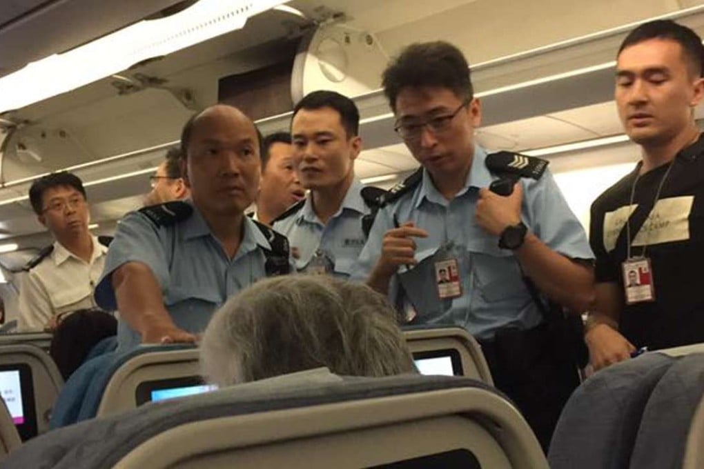 Police officers met the flight on arrival at Hong Kong International Airport. Photo: SCMP Pictures