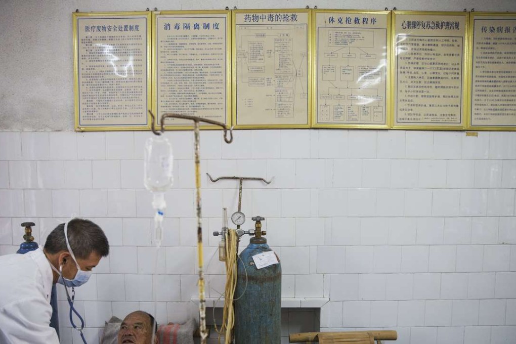 In mainland China, the government decides how many people it needs to employ in senior positions at public hospitals, rather than the facilities themselves. Pictured, a doctor and patient at Yangjia Hospital in Wuyi county, Zhejiang province. Photo: Reuters