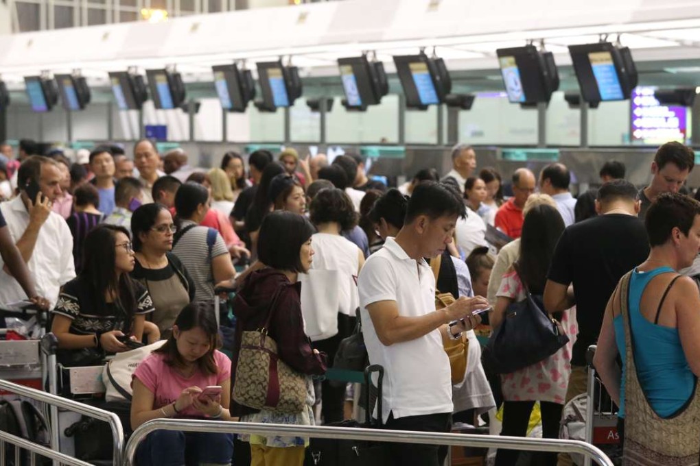 Passenger queue at Hong Kong International Airport on Monday. Photo: K. Y. Cheng