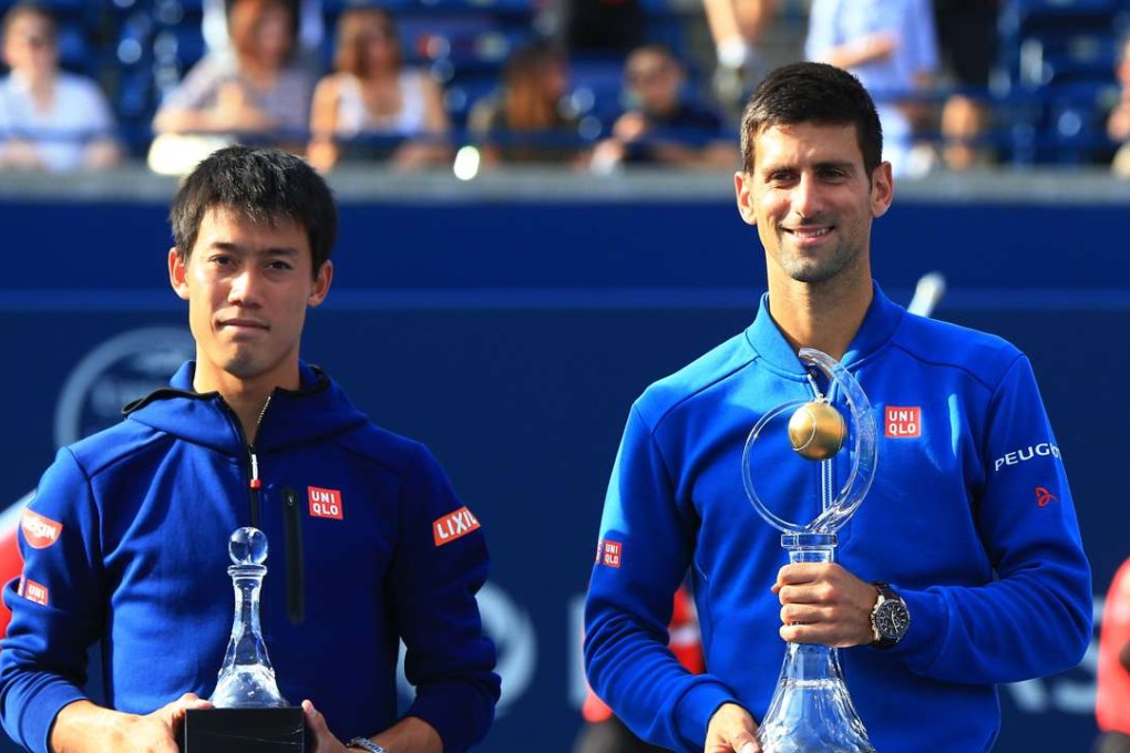 Kei Nishikori of Japan with Novak Djokovic after the Serbian secured the Rogers Cup title in Toronto. Photo: Xinhua
