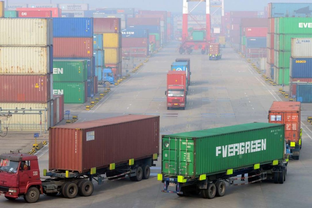 Cargo trucks drive through a container pool at a seaport in Qingdao, Shandong province. Photo: AP