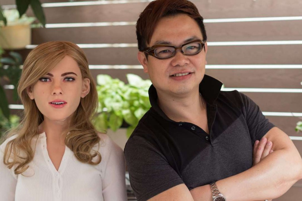 Ricky Ma stands next to his creation, a humanoid robot inspired by US actress Scarlett Johansson. Photo: EPA