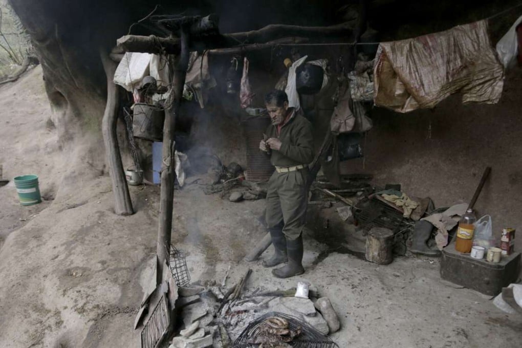 Pedro Luca cooks dinner inside a cave near San Pedro de Colalao, in Argentina's northern province of Tucuman. Luca has lived in the cave in northern Argentina for 40 years. Photo: AP