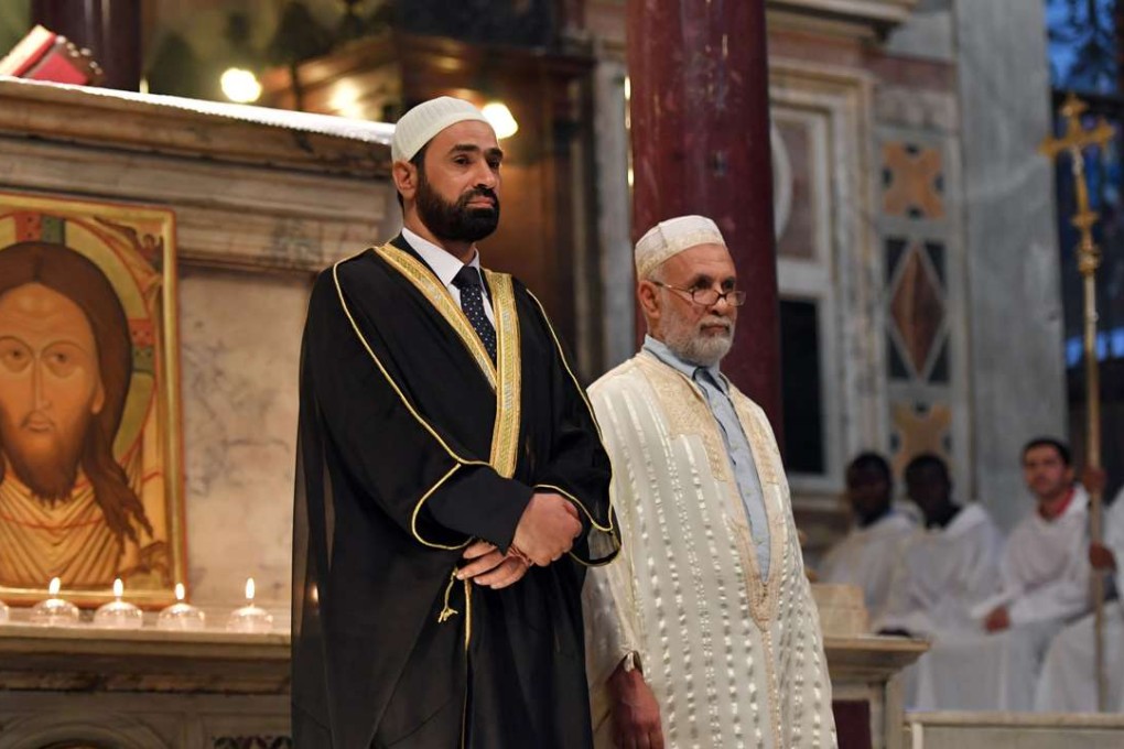 Imams Sami Salem (left) and Mohammed ben Mohammed stand during a mass in the church Santa Maria in Trastevere in Rome on Sunday. Photo: AFP
