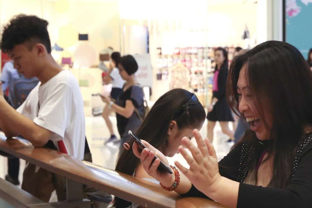 A happy customer playing Pokemon Go at Olympian City in West Kowloon. Shopping mall owners in Hong Kong are having to come up with creative ways of attracting more visitors, as numbers from the mainland continue falling. Photo: Sam Tsang