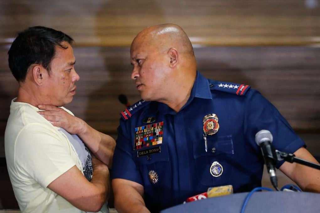 Filipino Mayor of Albuera town in Leyte Rolando Espinosa, who is allegedly involved in the drug trade, looks on as Philippine National Police Director General Ronald Dela Rosa speaks to him after Espinosa surrendered. Photo: EPA