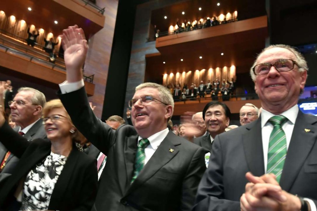 International Olympic Committee (IOC) President Thomas Bach (C) and President of the Rio 2016 Olympic Organizing Committee Carlos Arthur Nuzman (R) applaud during the opening ceremony of the 129th International Olympic Committee session, in Rio de Janeiro. Photo: AFP